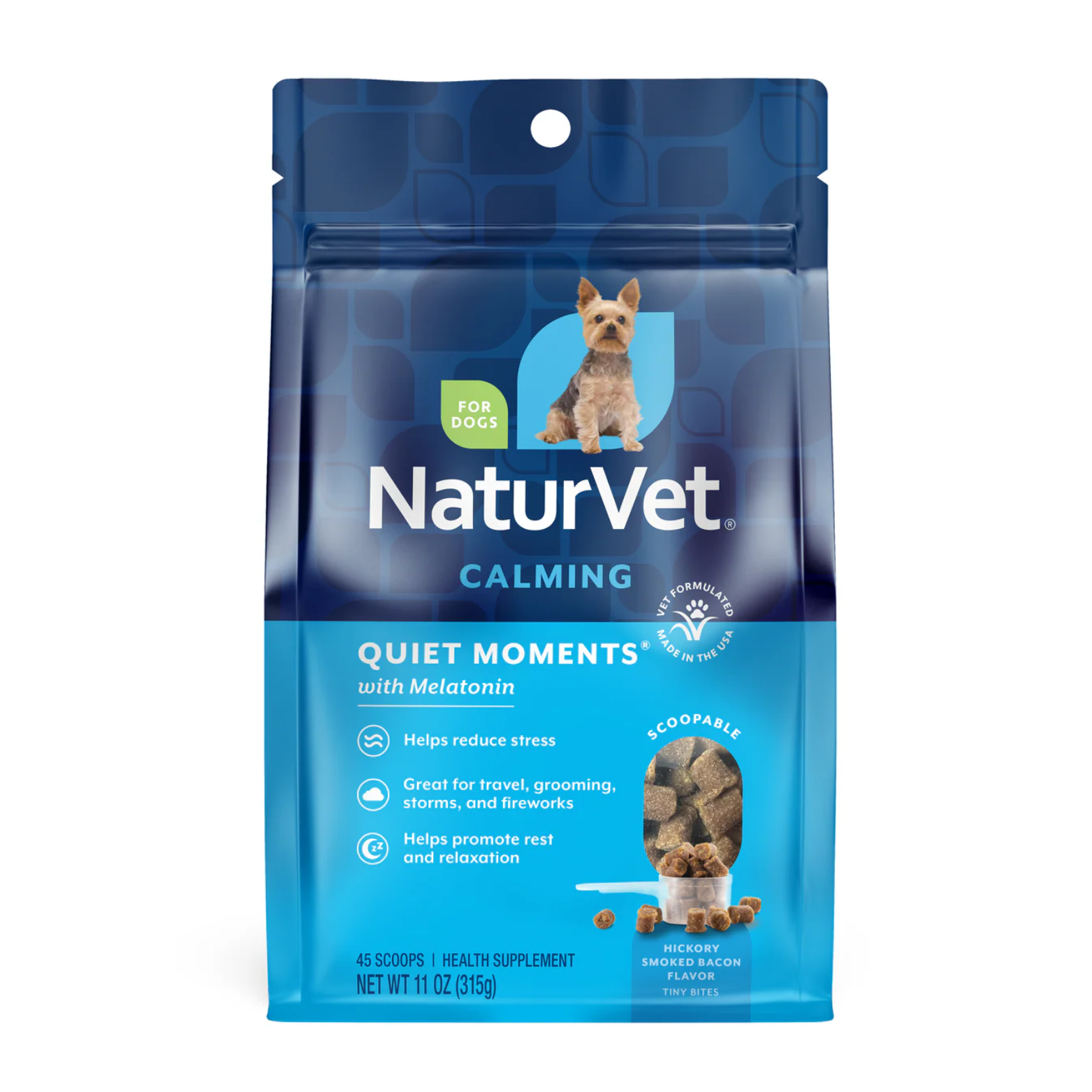 Blue resealable pouch of NaturVet Quiet Moments Calming dog supplement with melatonin. The front shows a small dog illustration, “For Dogs” label, scoopable soft chews, and hickory smoked bacon flavor. Net weight 11 oz.
