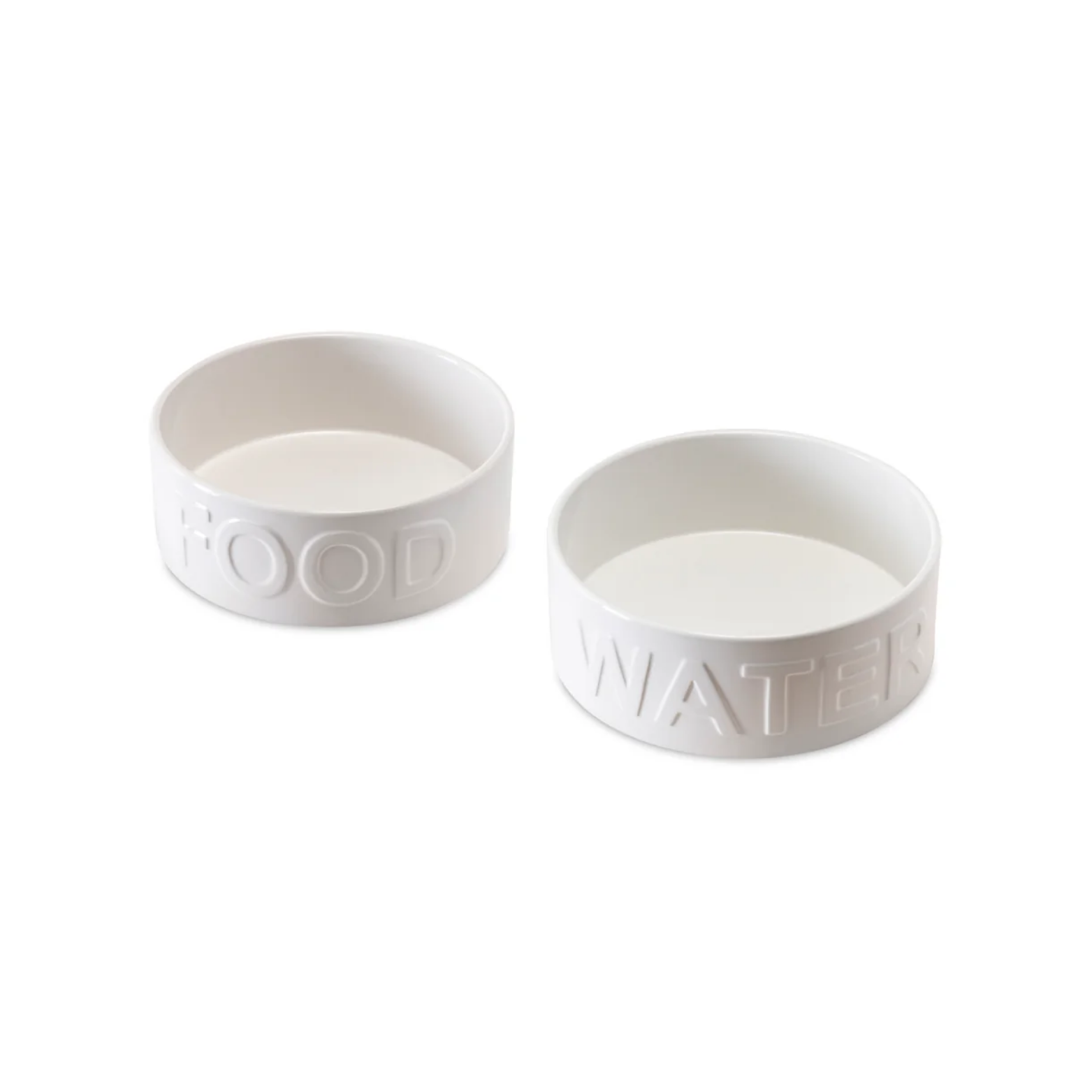 Two white ceramic pet bowls shown on a white background, one embossed with the word “FOOD” and the other with the word “WATER.”