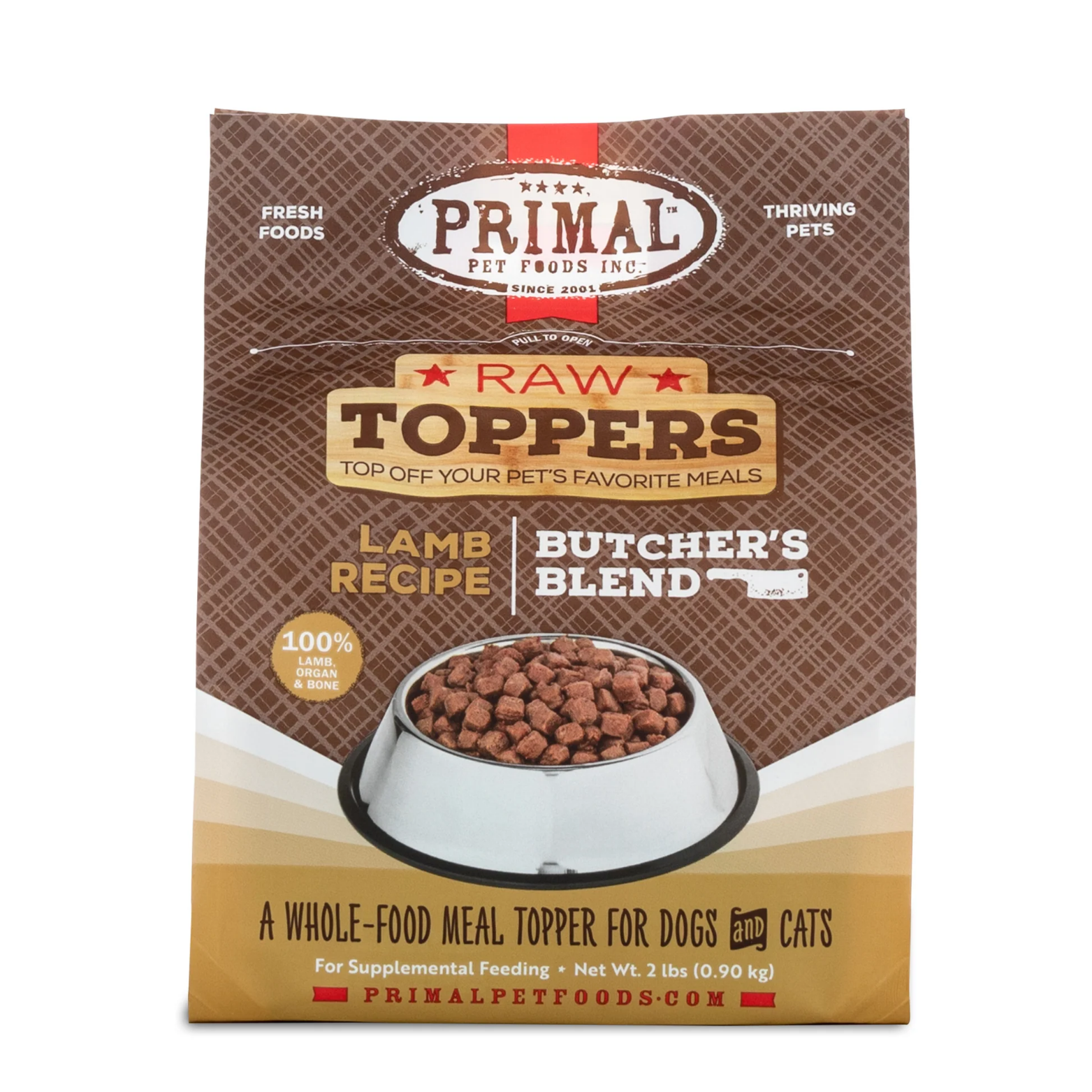 Front of a Primal Pet Foods Raw Toppers bag labeled “Lamb Recipe Butcher’s Blend,” showing a bowl of cube-shaped raw food pieces. The packaging states it is a whole-food meal topper for dogs and cats made with 100% lamb, organ, and bone, net weight 2 lb.