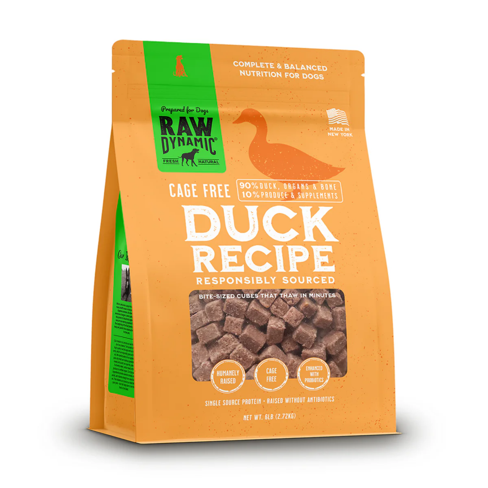 Orange stand-up bag of Raw Dynamic frozen dog food labeled “Duck Recipe.” The package features a green vertical banner with the Raw Dynamic logo, a silhouette of a duck, and text reading “Complete & Balanced Nutrition for Dogs” and “Made in New York.” A clear window shows small frozen meat cubes. Claims include “Cage Free,” “90% duck, organs & bone, 10% produce & supplements,” “Humanely raised,” and “Enhanced with probiotics.” Net weight is 6 lb (2.72 kg).