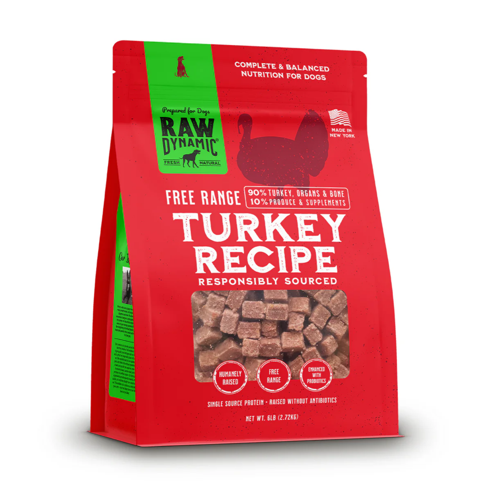 Red stand-up bag of Raw Dynamic frozen dog food labeled “Turkey Recipe.” The package features a green vertical banner with the Raw Dynamic logo, a silhouette of a turkey, and text reading “Complete & Balanced Nutrition for Dogs” and “Made in New York.” A clear window shows small frozen meat cubes. Claims include “Free Range,” “90% turkey, organs & bone, 10% produce & supplements,” “Humanely raised,” and “Enhanced with probiotics.” Net weight is 6 lb (2.72 kg).