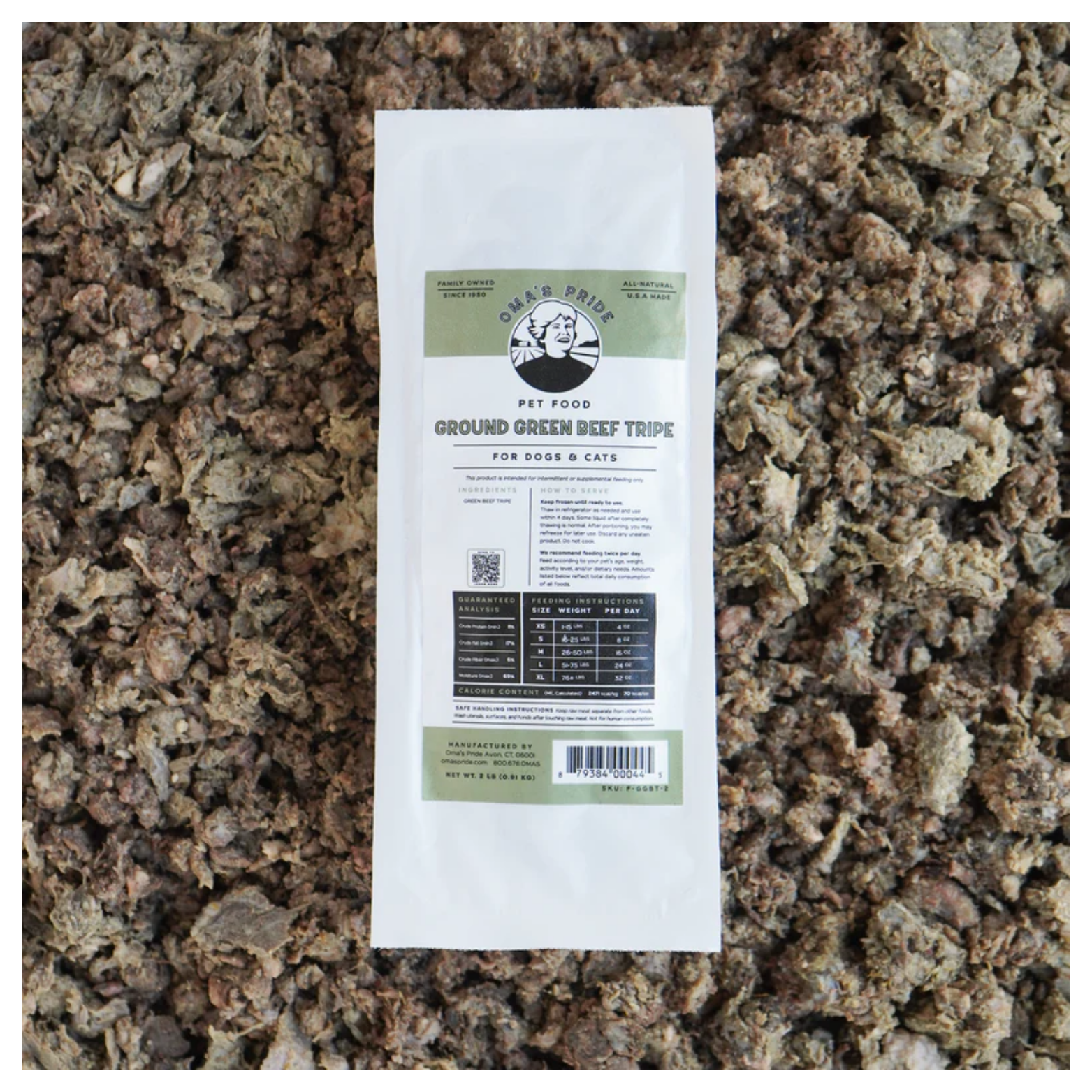 A sealed package of Oma’s Pride Ground Green Beef Tripe frozen pet food placed on a background of ground beef tripe.