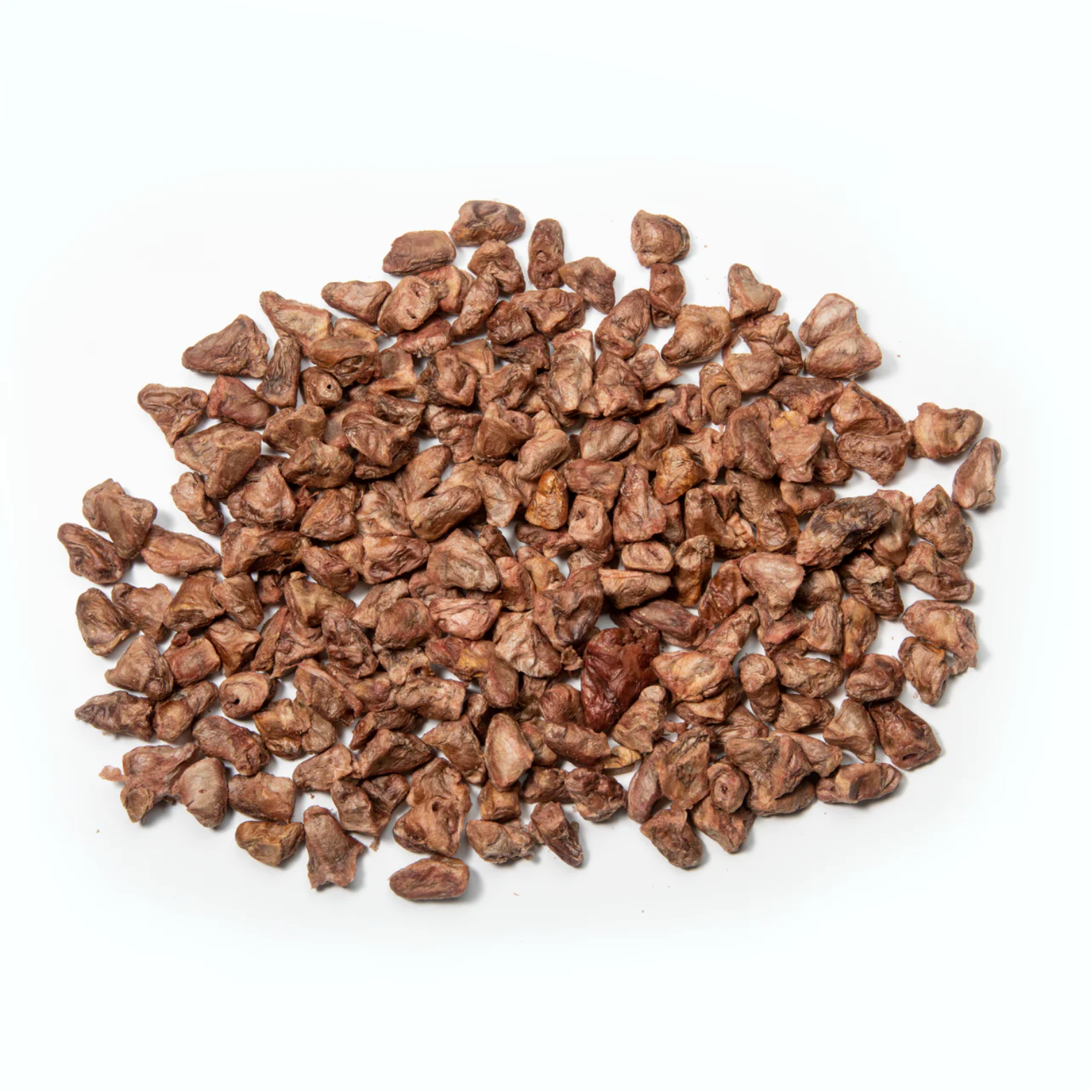 Assortment of small, brown freeze-dried chicken heart treats spread on a light gray background, showing varied shapes and textures.
