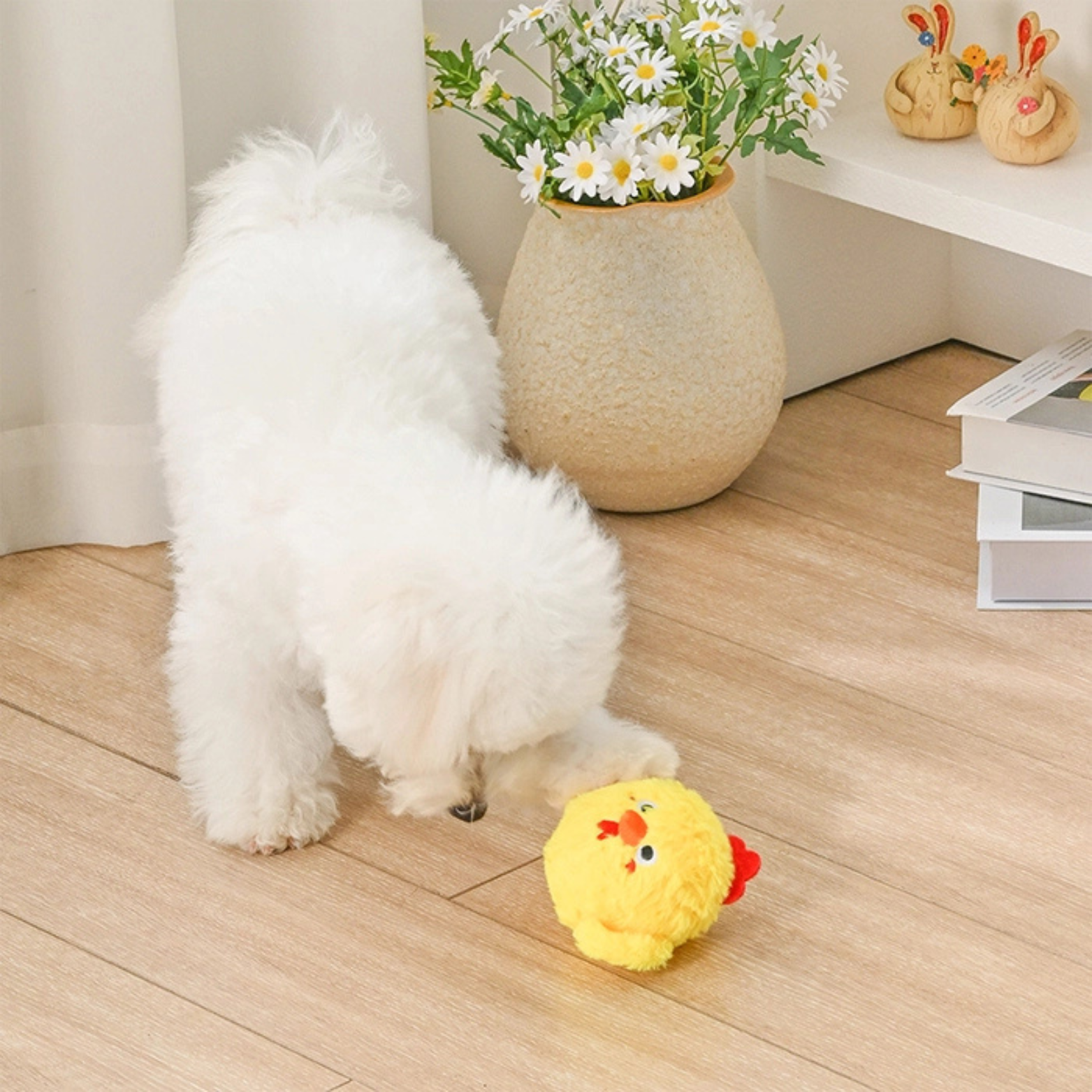 White dog playing with a yellow plush toy on a wooden floor.