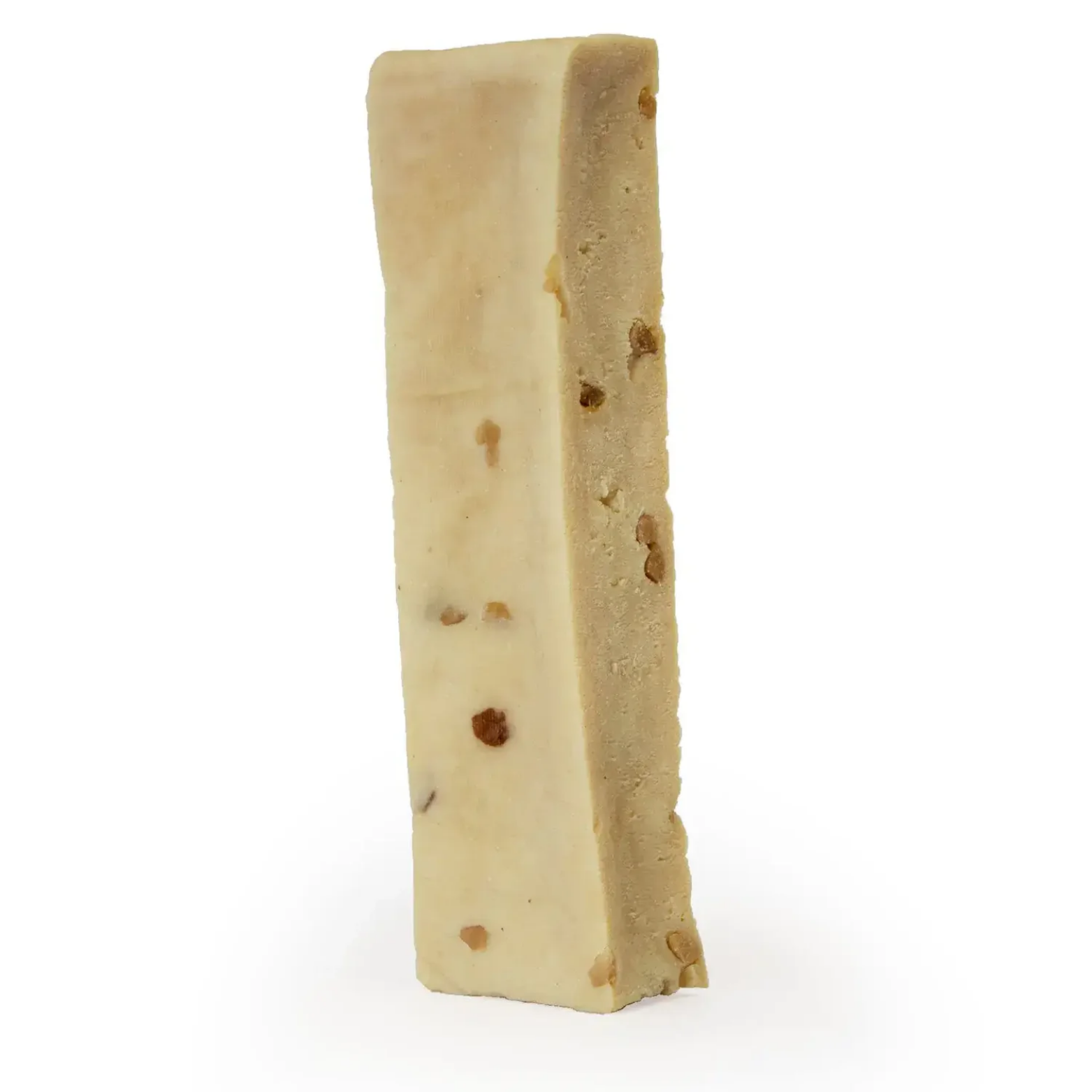 Single Himalayan cheese dog chew with visible flavor inclusions displayed upright on a white background. The chew is rectangular, light beige in color, and has a dense, smooth texture.