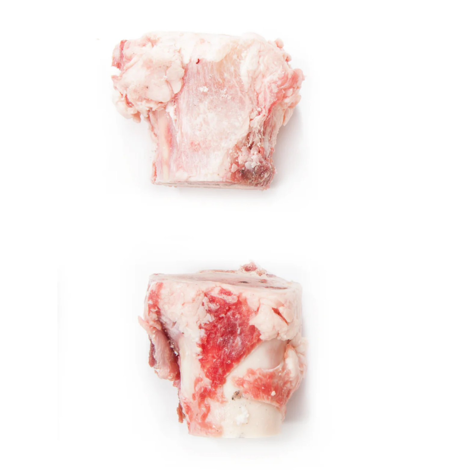 Two raw frozen beef marrow bones placed separately on a white background, showing pale bone with red meat and fat attached.