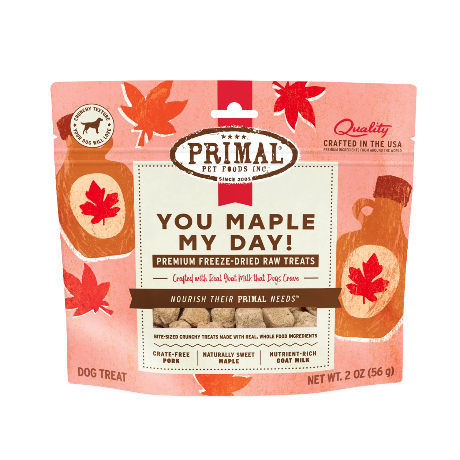 A pink and cream-colored resealable bag of "Primal Pet Foods" dog treats. The product name is "YOU MAPLE MY DAY!" in large, bold brown letters. The bag features illustrations of autumn maple leaves and a syrup bottle. Key highlights at the bottom state: Crate-Free Pork, Naturally Sweet Maple, and Nutrient-Rich Goat Milk. A small circular badge in the corner notes a "Crunchy Texture."