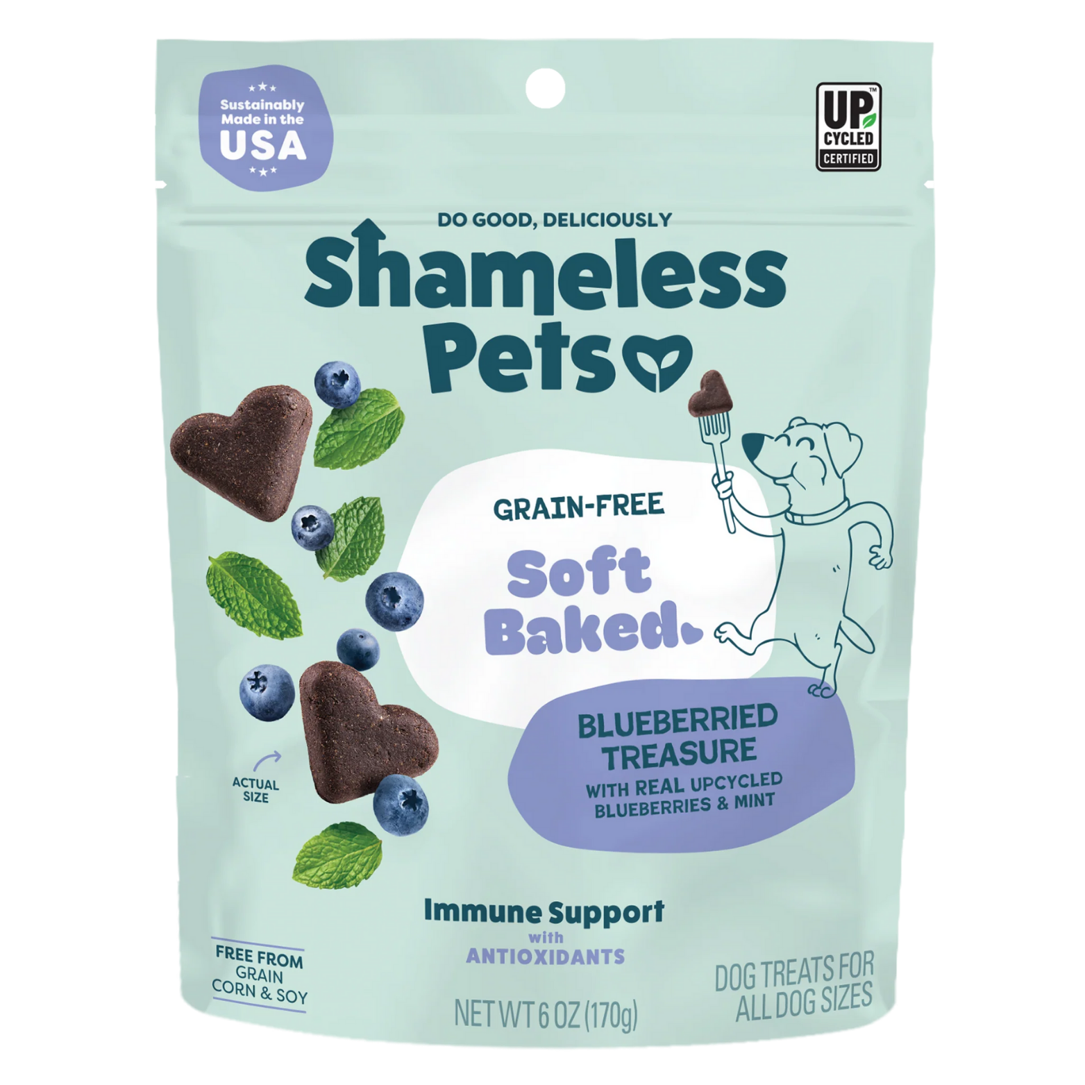Front view of a light teal Shameless Pets dog treat bag labeled “Grain-Free Soft Baked Blueberried Treasure,” featuring heart-shaped dark brown treats, blueberries, and mint leaves, with icons noting sustainably made in the USA, upcycled ingredients, immune support with antioxidants, and dog treats for all dog sizes.