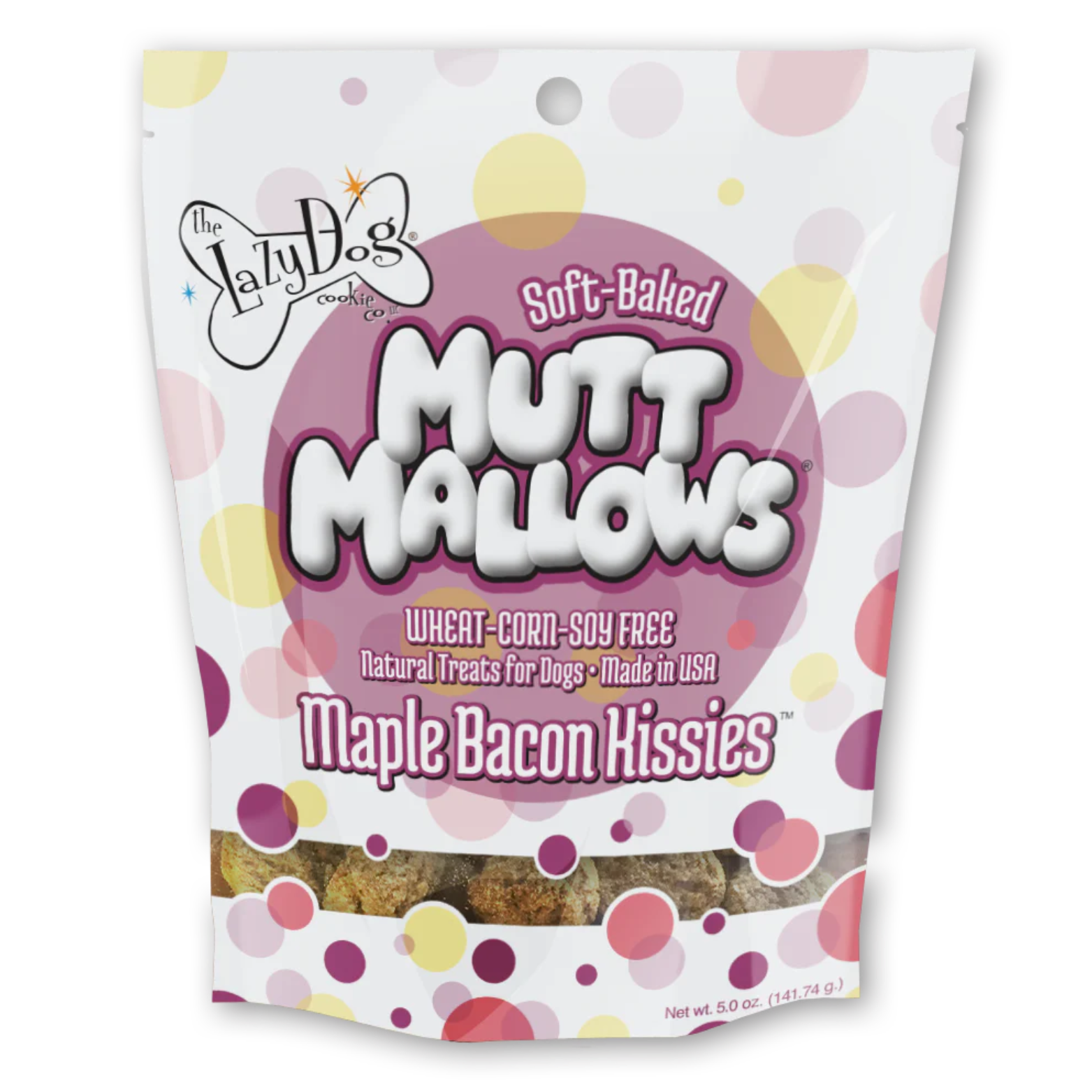 White bag of The Lazy Dog Cookie Co. Soft-Baked Mutt Mallows dog treats with pink and yellow polka dots, labeled “Maple Bacon Kissies,” wheat-corn-soy free, made in the USA, with a window showing round brown treats inside.