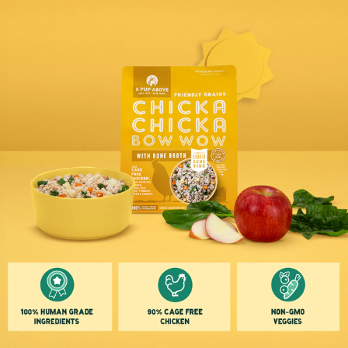 Yellow bag of A Pup Above Chicka Chicka Bow Wow dog food displayed with a bowl of the cooked food, fresh ingredients including an apple, spinach, and sliced pieces, and icons highlighting 100% human-grade ingredients, 90% cage-free chicken, and non-GMO veggies.