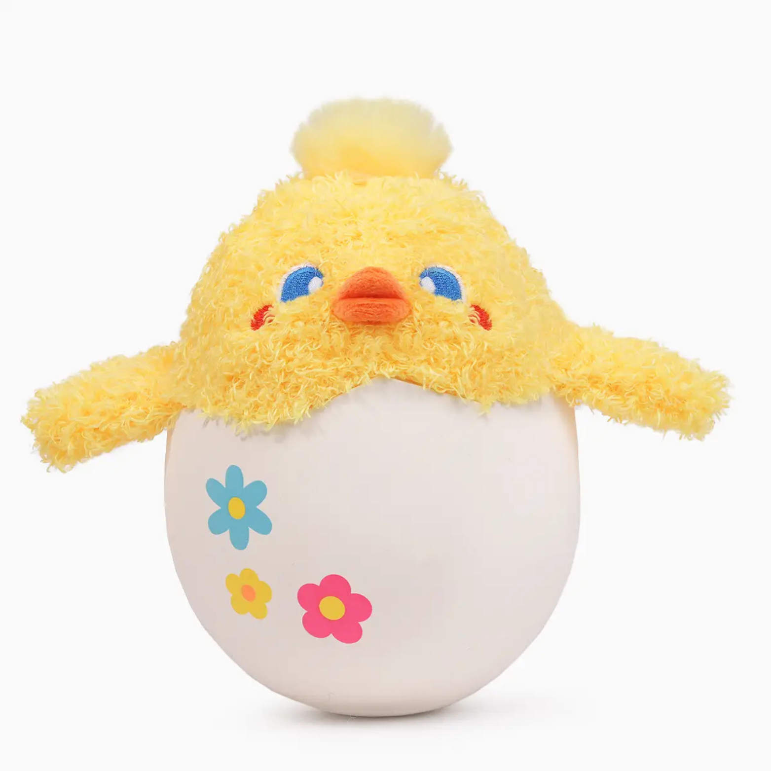 Plush toy chick emerging from an egg with colorful flowers on a white background